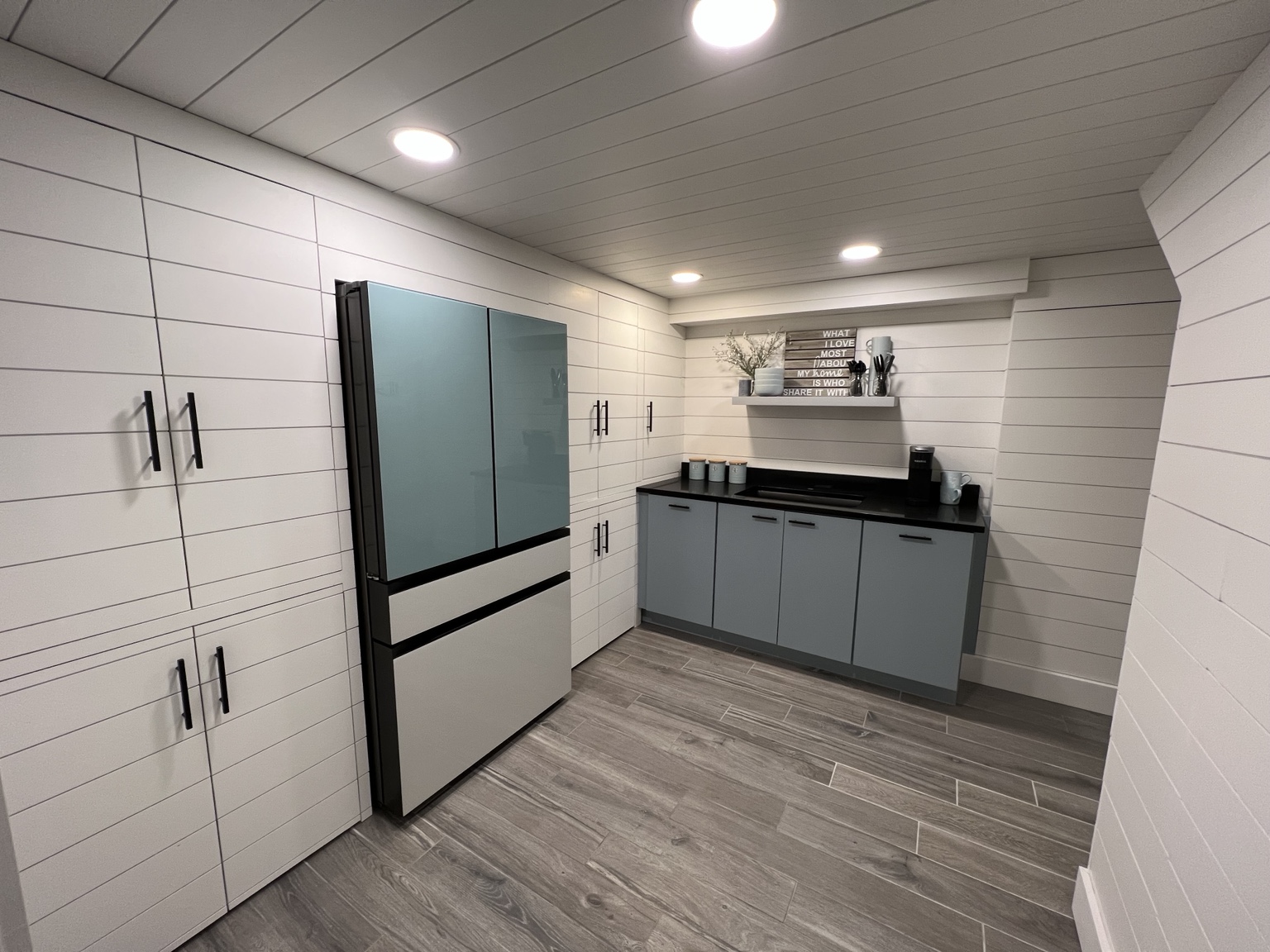 Shiplap beverage room with built-in storage