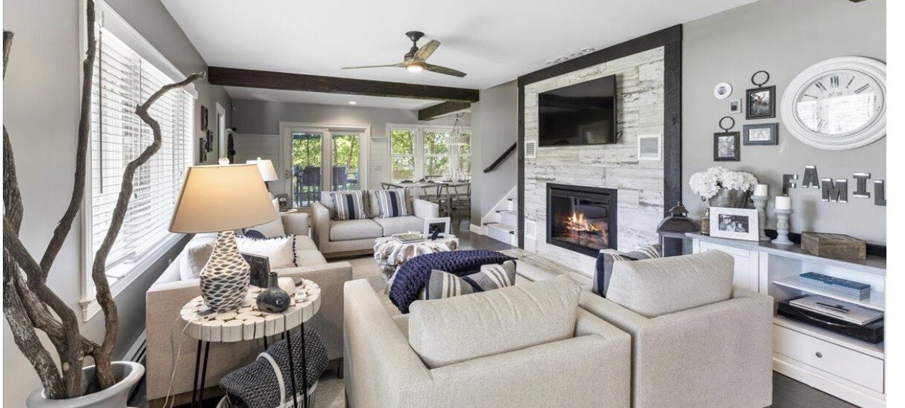Lake house living room with fireplace and natural accents