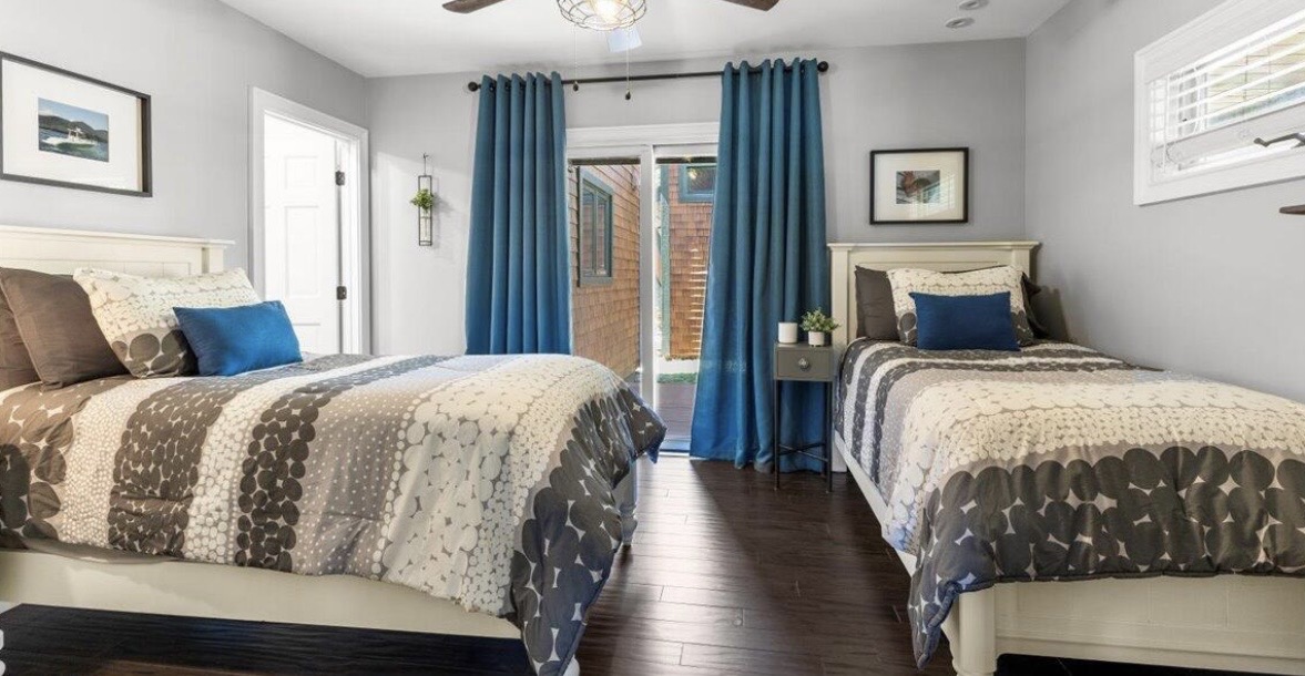 Twin guest room with blue drapery