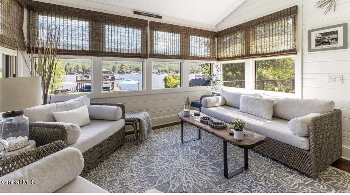 Waterfront sunroom with woven seating
